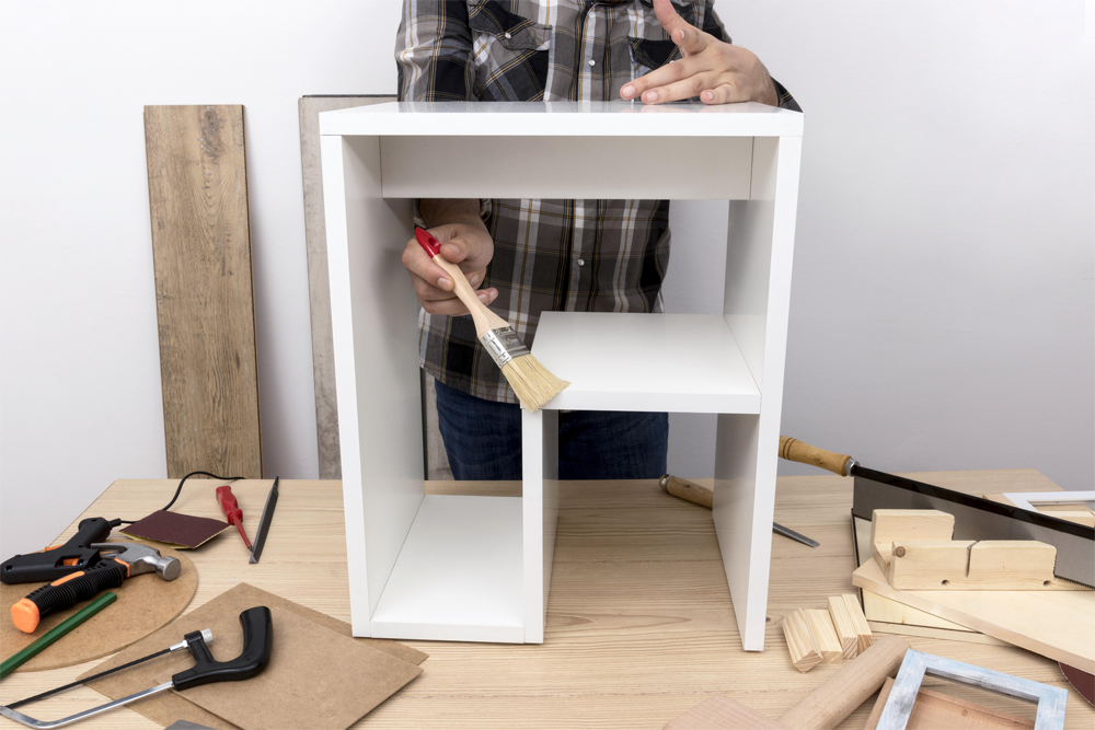 man-creating-cabinet-from-wood-front-view